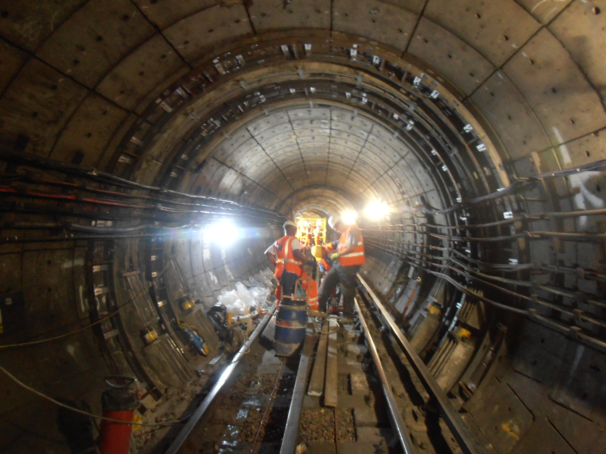 3 site operatives carrying out investigations inside a tunnel