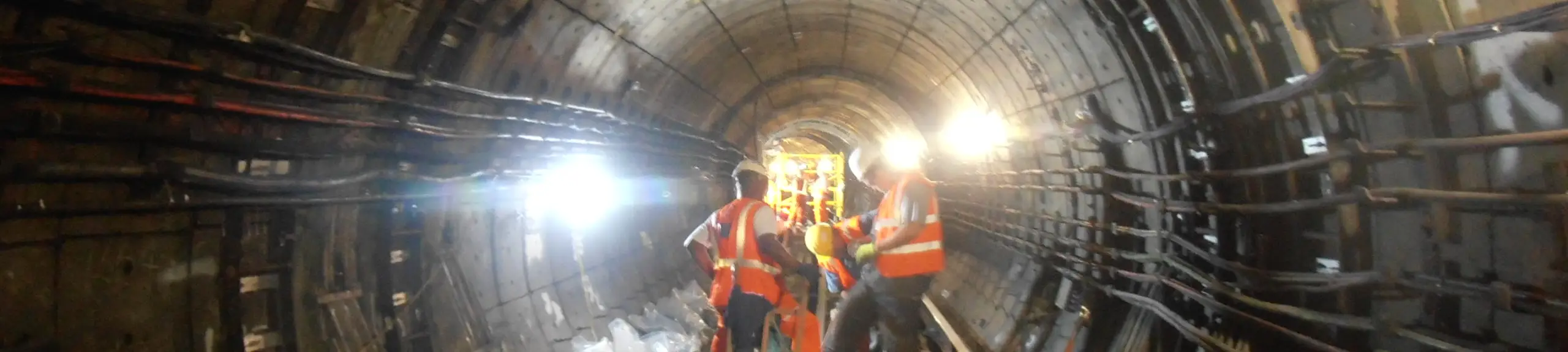 3 site operatives carrying out investigations inside a tunnel 3 site operatives carrying out investigations inside a tunnel