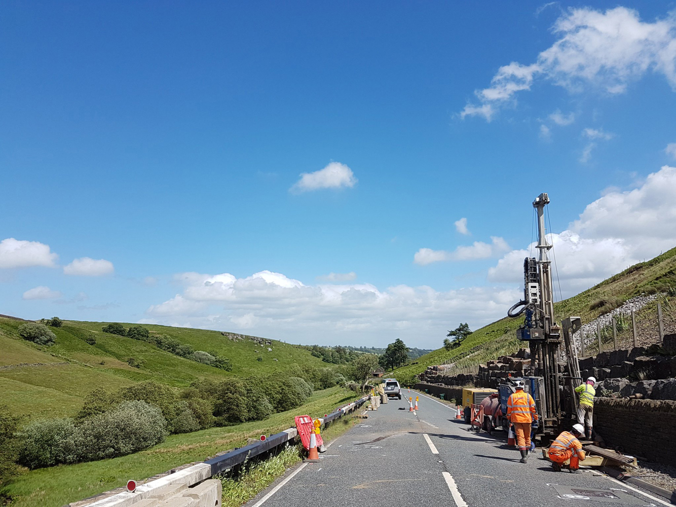 Rotary rig set up on the side of a country road drilling a borehole Rotary rig set up on the side of a country road drilling a borehole